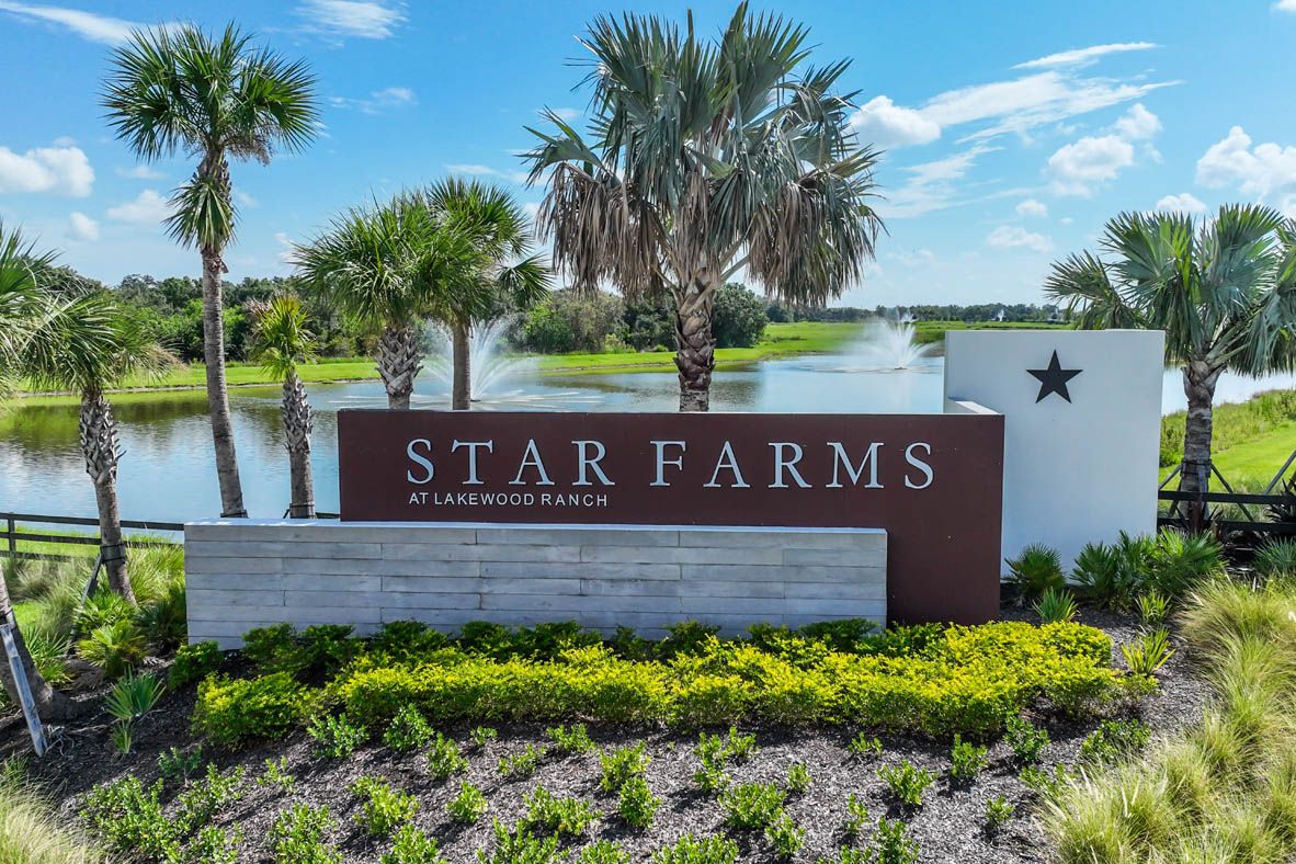 Star Farms at Lakewood Ranch community entrance monument surrounded by palms and lake fountains